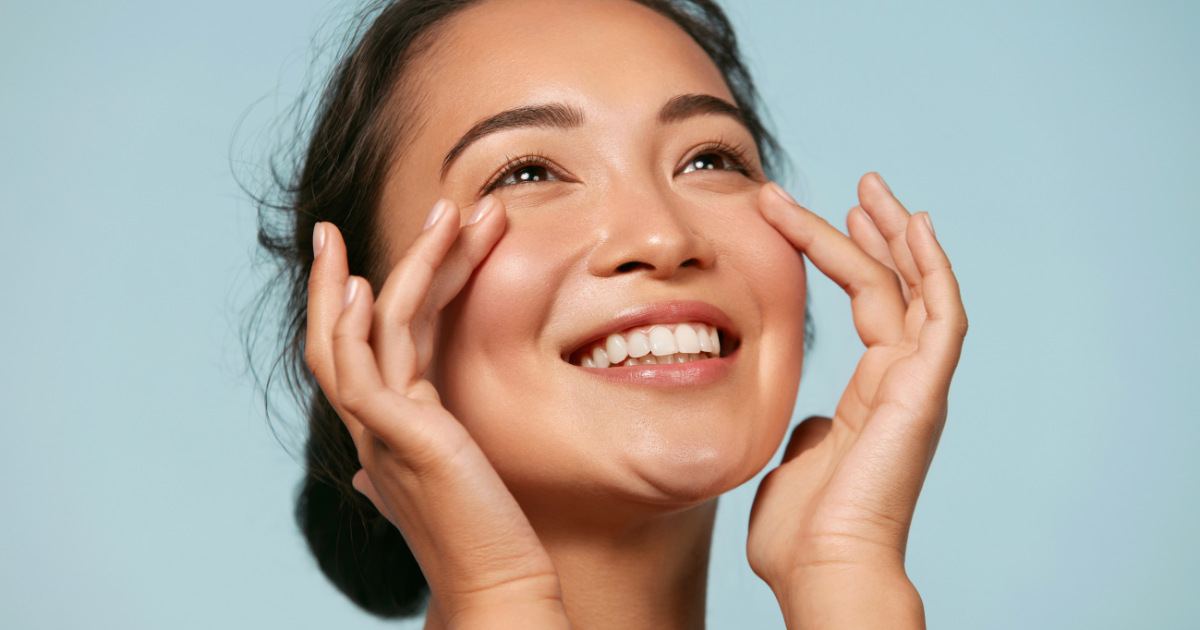 image of a woman touching her skin