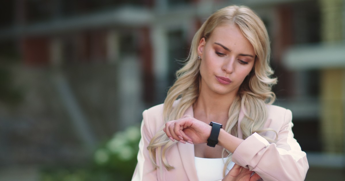 A woman looking on a watch