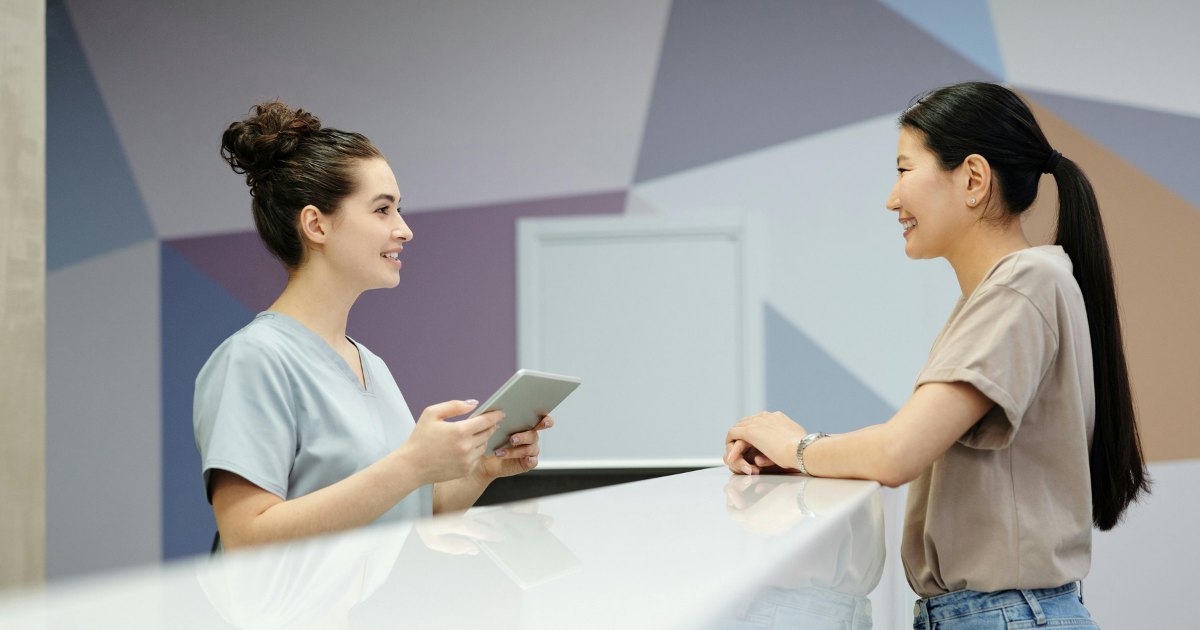 A woman patient talking to a sculptra provider