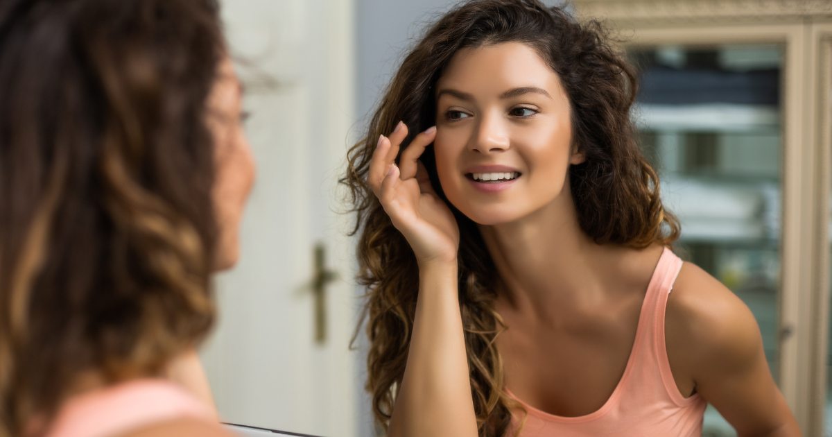 A woman looking at a mirror