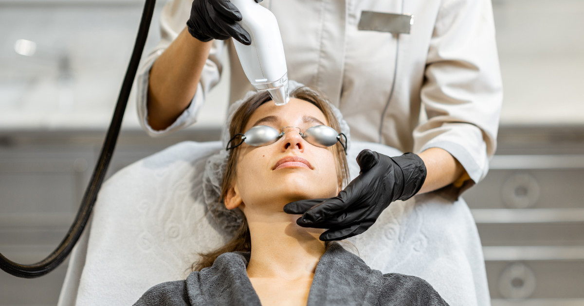 A woman receiving a laser facial treatment